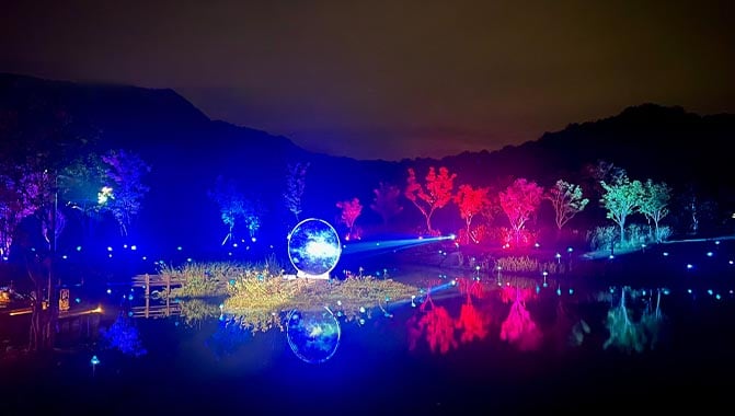 A calm Nanbei Lake adorned with colorful projections, capturing the essence of a vibrant night landscape.
